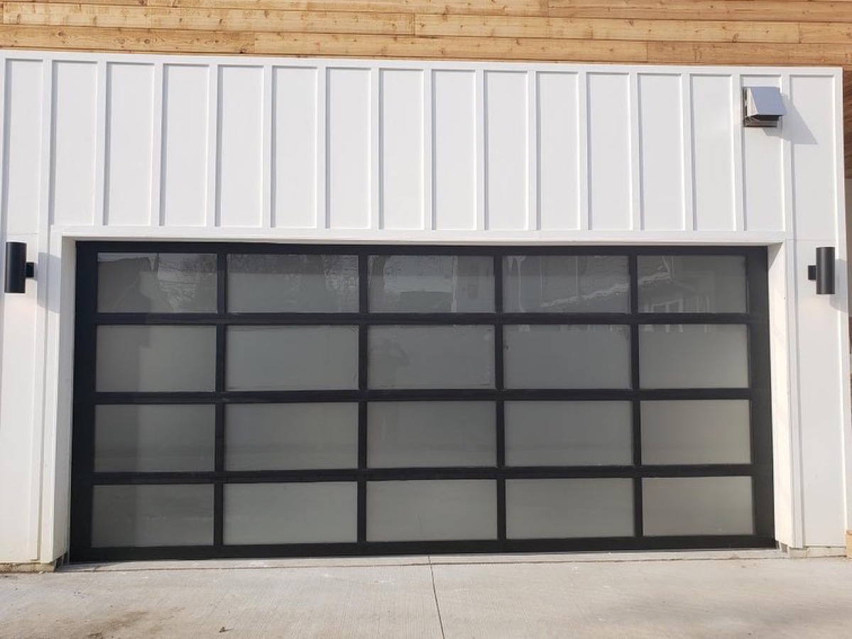 Contemporary glass and aluminium overhead door installed by Prolift